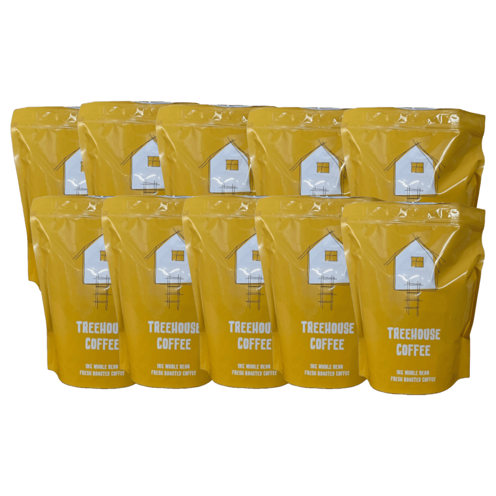 Treehouse coffee. Ten yellow bags of Treehouse Coffee with a white house logo, arranged in two rows. The bags display the text Treehouse Coffee, 100% Arabica Beans, Fresh Roasted Coffee.