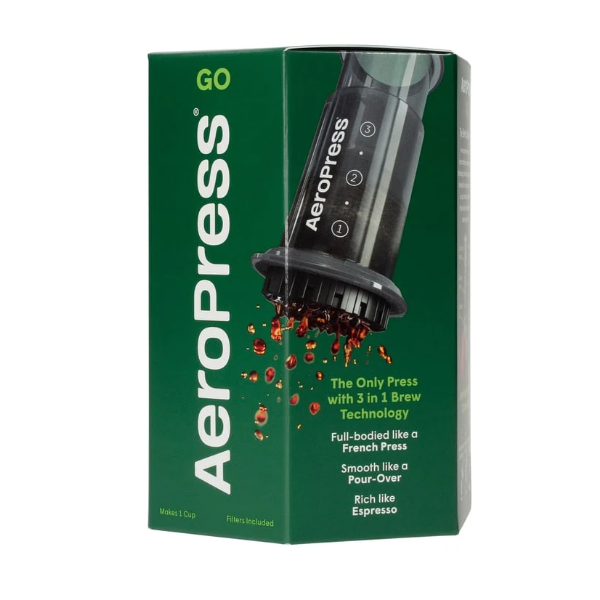 Badger & Dodo. Compact green box of the Aeropress Go Travel Kit, featuring an image of the coffee maker and coffee drops—an ideal travel companion with key features displayed on the front.