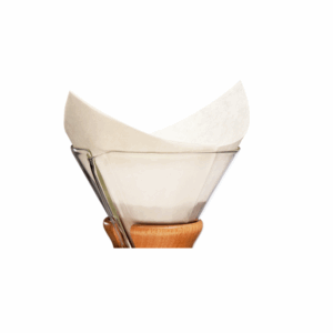 Chemex coffee maker with a folded paper filter placed inside the glass funnel, featuring a wooden collar and leather tie around the neck, displayed on a white background.