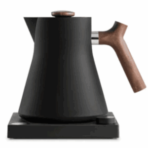 Modern black electric kettle with a matte finish, featuring a wooden handle and lid knob, placed on a square base with a control dial.