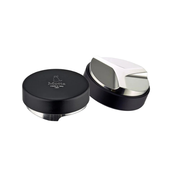 A Motta coffee distribution and leveling tool, made in Italy. The tool has a sleek black and stainless steel design with a flat base and an adjustable leveling blade. One unit is shown with the top view featuring the Motta logo, while the other is flipped to display the angled distribution base.