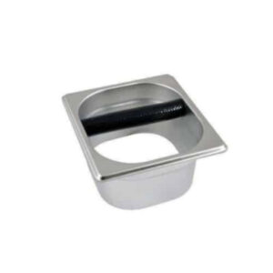 Badger and Dodo Coffee Roasters: The Open Knock Out Box is a square, stainless steel container featuring a circular opening and a black rod in the middle, ideal for disposing of used coffee grounds.