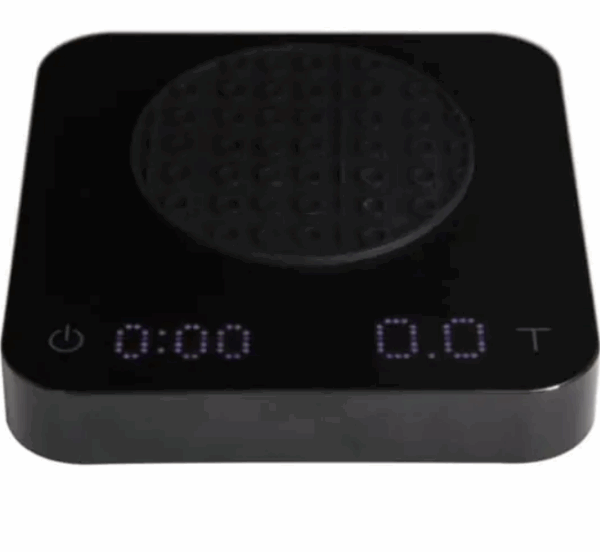 Badger and Dodo Coffee Roasters: The Acaia Pearl S - Black kitchen scale includes a digital display with 0:00 on the left and 0.0T on the right, perfect for coffee lovers. Its round, textured weighing surface and bottom-left power button ensure precision brewing is simple and effective.