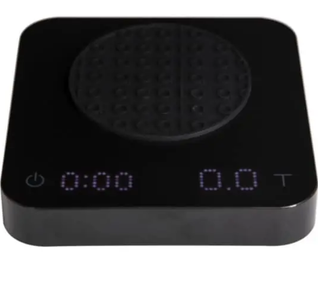 Badger and Dodo Coffee Roasters: The Acaia Pearl S - Black kitchen scale includes a digital display with 0:00 on the left and 0.0T on the right, perfect for coffee lovers. Its round, textured weighing surface and bottom-left power button ensure precision brewing is simple and effective.