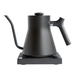 Badger & Dodo. The FELLOW STAGG EKG Electric Pouring Kettle in matte black features a wide base, curved gooseneck spout, and ergonomic handle for precise pouring and modern style.
