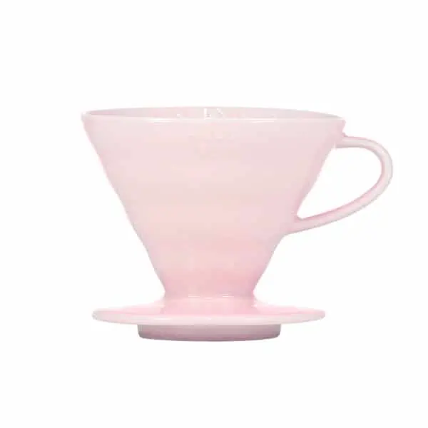 Badger and Dodo Coffee Roasters: Experience the elegance of the pink Hario V60 ceramic dripper, crafted for exquisite pour-over brewing. This conical beauty, with its ergonomic handle and flat base, stands out against a crisp white background, promising a perfect brew every time.