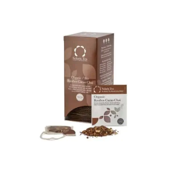 Badger and Dodo Coffee Roasters: A box of Solaris Teas Organic Rooibos Cacao Chai, featuring an individual tea sachet and loose leaves artfully displayed. The packaging is a warm brown, adorned with the brand’s elegant white text and logo.
