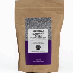 Badger and Dodo Coffee Roasters: On a brown paper bag, labeled Mumbai Railway Chai (1kg), a purple and white label with a black pattern boasts the chais 100% natural, vegan, and sugar-free qualities. Filled with exotic spices, it promises an authentic chai experience.
