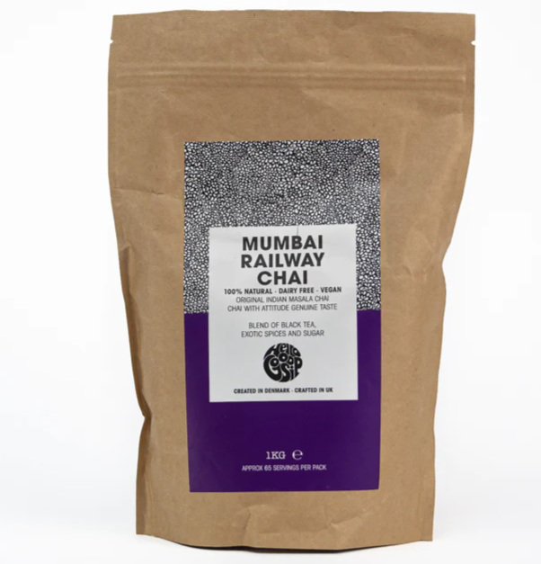 Badger and Dodo Coffee Roasters: On a brown paper bag, labeled Mumbai Railway Chai (1kg), a purple and white label with a black pattern boasts the chais 100% natural, vegan, and sugar-free qualities. Filled with exotic spices, it promises an authentic chai experience.