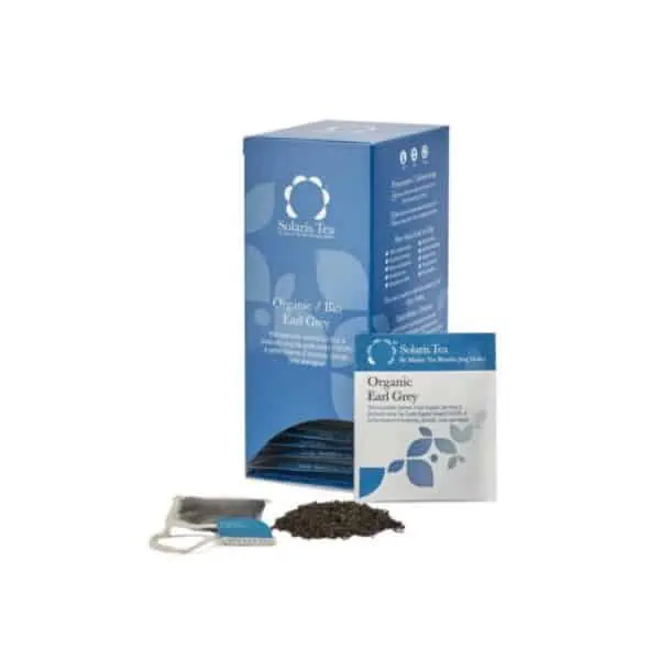 Badger and Dodo Coffee Roasters: A box of Solaris Earl Grey tea showcases the text Organic Earl Grey. A tea bag and loose leaf sit in front, inviting you to indulge. The packaging features a blue and white palette adorned with elegant leaf designs, perfectly capturing the essence of Solaris craftsmanship.