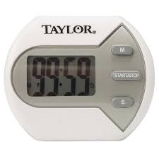 A digital kitchen timer by Taylor, displaying 00:59 seconds on the screen. The timer is white with a circular display and has three buttons labeled “M” (minutes), “START/STOP,” and “S” (seconds) on the right side.