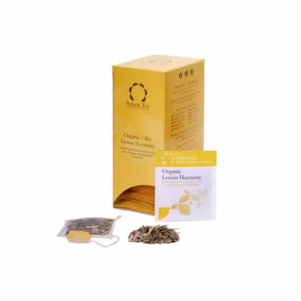 Badger and Dodo Coffee Roasters: A yellow box of Organic Lemon Harmony tea by Solaris, with an open sachet revealing dried leaves and a tea bag. The minimalist design features leaf motifs on both the sachet and the box, exuding tranquility.